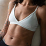 Organic cotton triangle bra with adjustable spaghetti straps. Breathable, wireless. Ideal for yoga, pilates, gym, or daily athleisure wear. Provides light support.