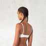 Organic cotton triangle bra with adjustable spaghetti straps. Breathable, wireless. Ideal for yoga, pilates, gym, or daily athleisure wear. Provides light support.